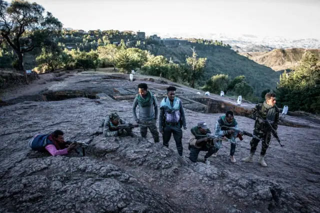 Amhara Fano militia fighters pose at Saint George Church in Lalibela, on December 7, 2021.