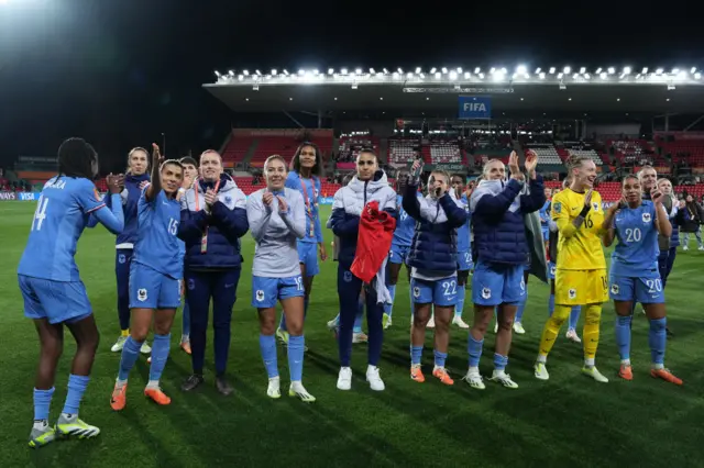 France players celebrate in front of their fans at full time.