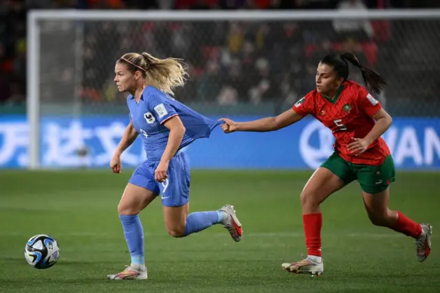 Le Sommer runs away from a Moroccan defender.