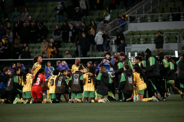 Jamaica players gather on the pitch after their win over Brazil.