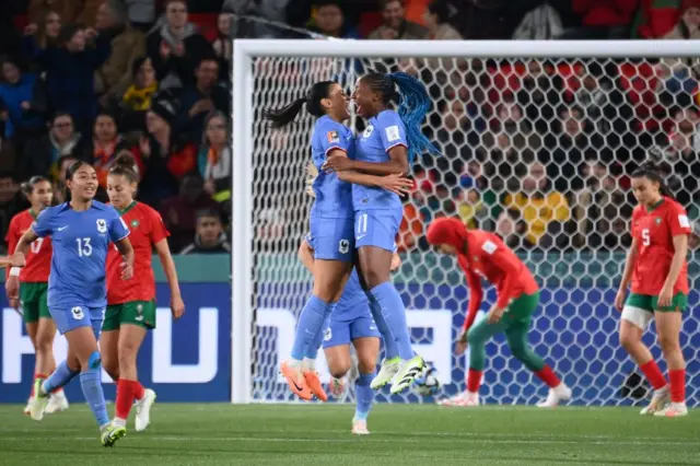 Diani and Dali celebrate by chest bumping after France score again.