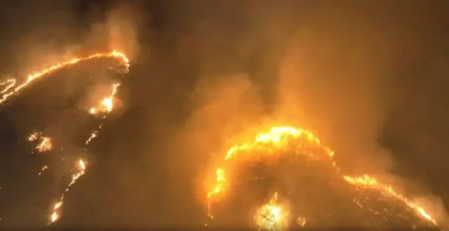 Rings of fire surrounded by smoke on a mountain