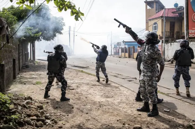 Police officers fire rubber bullets and teargas at supporters of the opposition party, All People's Congress (APC), during a protest calling for the Chief electoral Commissioner, Mohamed Konneh, to step down after allegations of electoral fraud in Freetown on June 21, 2023.