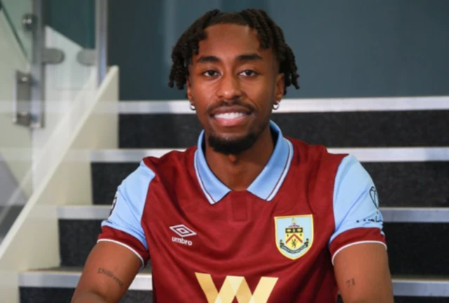 Mike Tresor poses in a Burnley kit