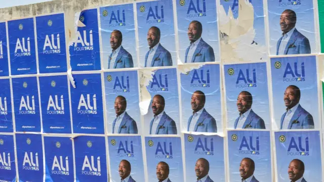 Posters of ousted President Ali Bongo Ondimba are displayed on a wall in Libreville, Gabon, 31 August 2023.