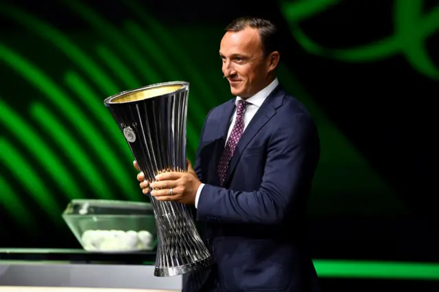 Mark Noble brings out the UEFA Europa Conference League trophy during the UEFA Europa Conference League 2023/24 Group Stage Draw.