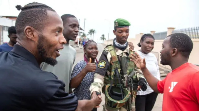 A joyful group of Gabonese embracing a Republican Guard soldier, in Port-Gentil (economic capital), on August 30, 2023 after the announcement of the Coup d'Etat perpetrated by the Gabonese Defense and Security Forces - 30 August 2023