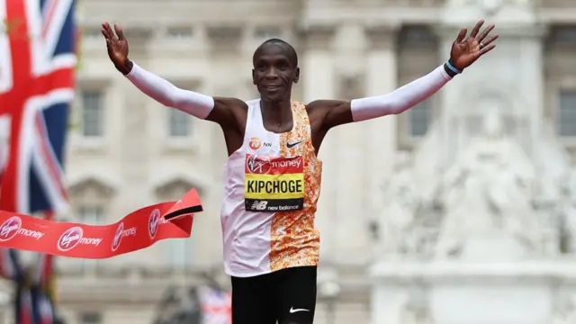 Eliud Kipchoge of Kenya crosses the finish line to win the Men's Elite race breaking the race record during the Virgin Money London Marathon at United Kingdom on April 28, 2019 in London, England.