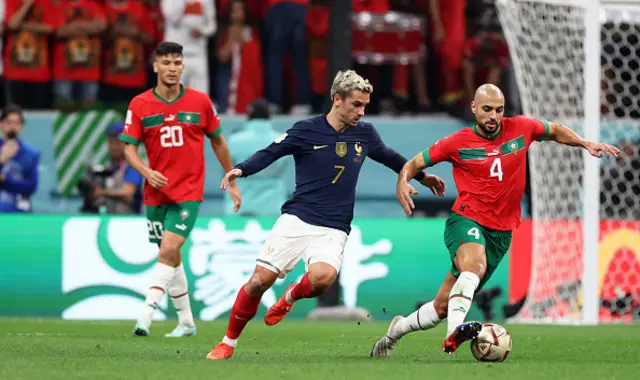 Sofyan Amrabat of Morocco looks to break past Antoine Griezmann