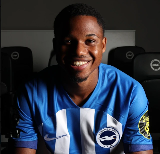 Ansu Fati smiles in a Brighton shirt