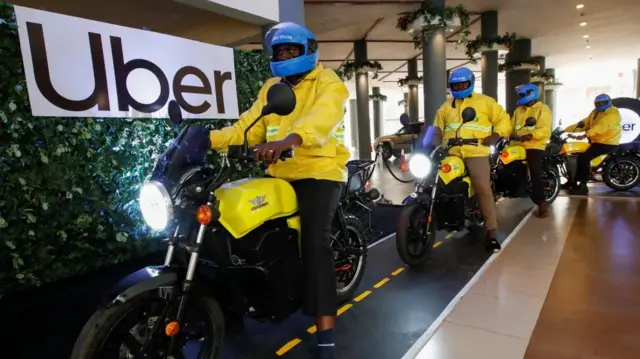 Uber boda boda riders prepare to ride the first fleet of the company's electric product