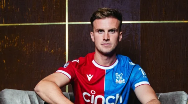 Rob Holding poses in a Crystal Palace shirt