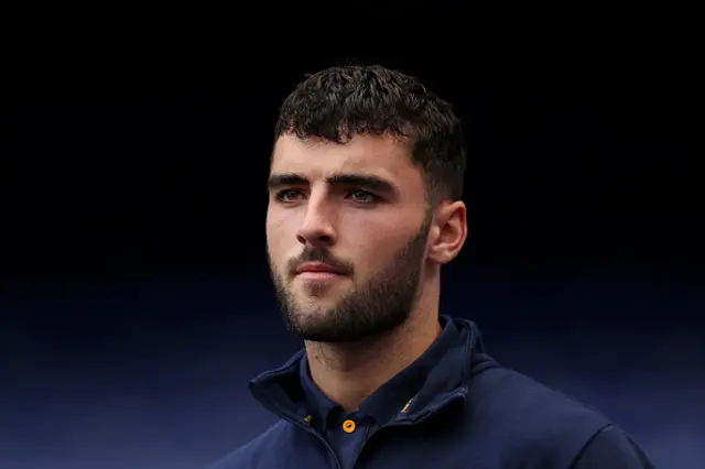 Tom Cannon looks on before a Premier League game