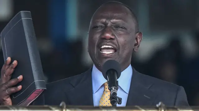 Incoming Kenyan President William Ruto takes the oath of office at the Moi International Sports Center Kasarani in Nairobi, Kenya, on September 13, 2022 during the inauguration ceremony. - William Ruto was sworn in as Kenya's fifth post-independence president at a pomp-filled ceremony on Tuesday, after his narrow victory in a bitterly fought but largely peaceful election.