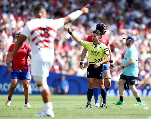 Referee Nic Berry awards Dylan Riley of Japan (not pictured) with a yellow card