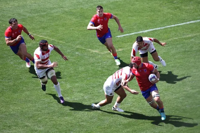 Chile's number eight Alfonso Escobar hands off a tackle