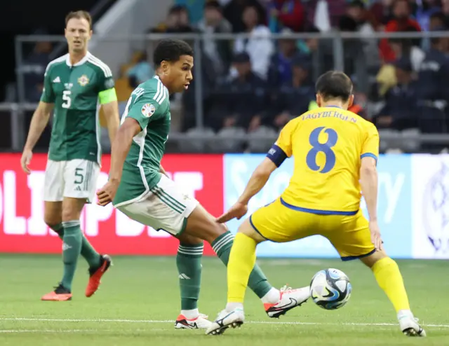 Kazakhstan's Askhat Tagybergen in action against Northern Ireland's Shea Charles