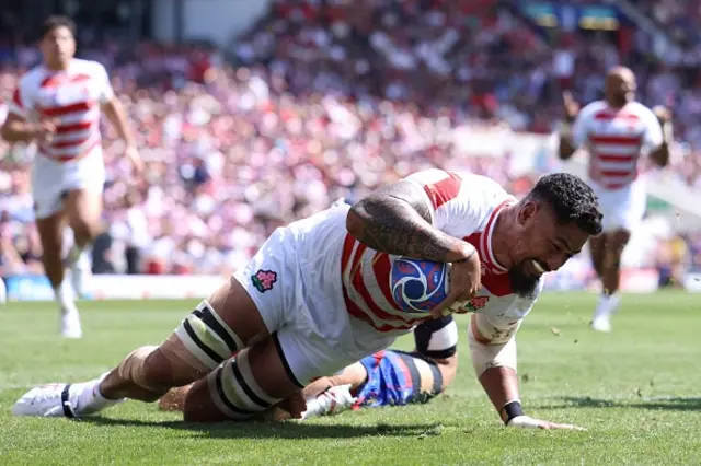 Amato Fakatava dives over the line to score Japan's first try