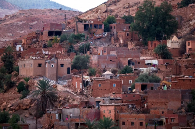 Rows of damaged red buildings in Tahnaout