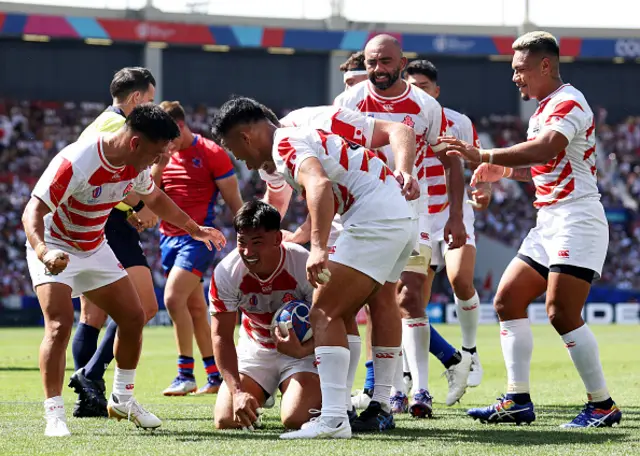 Ryoto Nakamura of Japan celebrates with teammates after scoring his team's fifth try