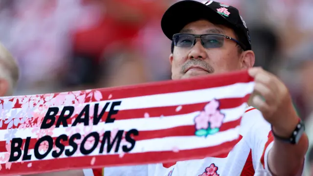 Japan fan holds scarf