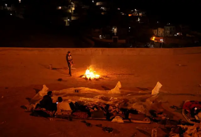 Night scene in Moulay Brahim - people camping out in open, 9 September 2023