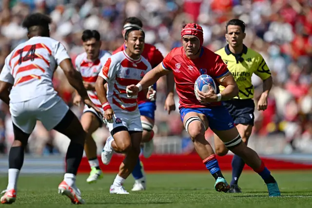 Alfonso Escobar of Chile on the ball ahead of Kotaro Matsushima