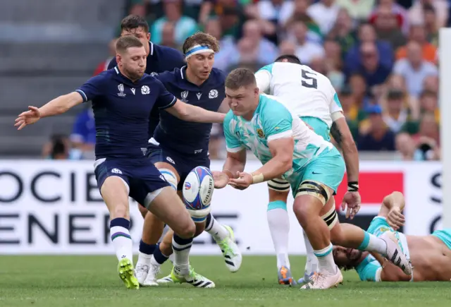 Finn Russell concedes a penalty, with Scotland under pressure