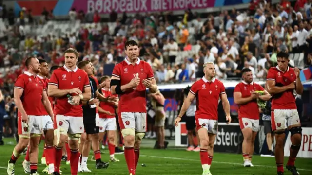 Wales players walk around the pitch