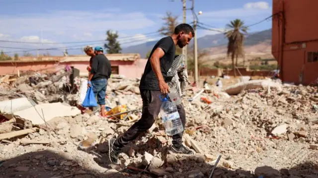 A man walks on rubble in Amizmiz