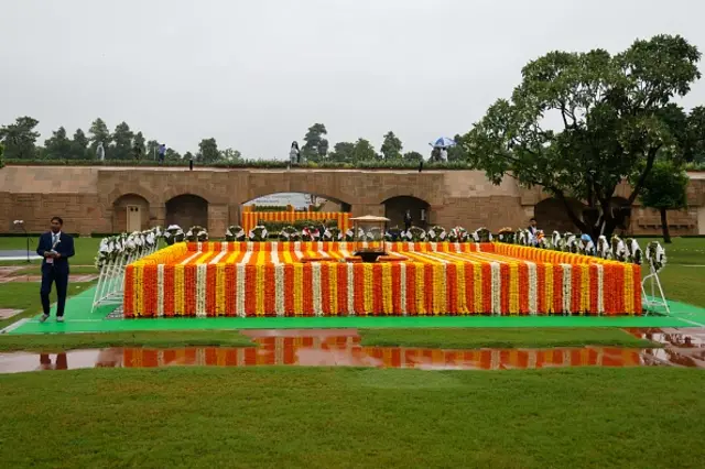 An Indian official stands at the Mahatma Gandhi memorial before the arrival of leaders at Rajghat on the sidelines of the G20 summit in New Delhi on September 10, 2023.