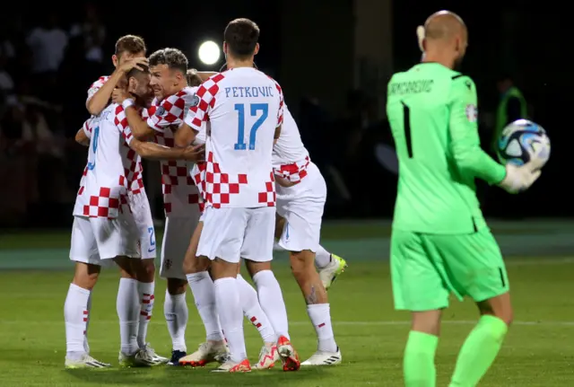 Croatia players celebrate scoring a goal against Armenia