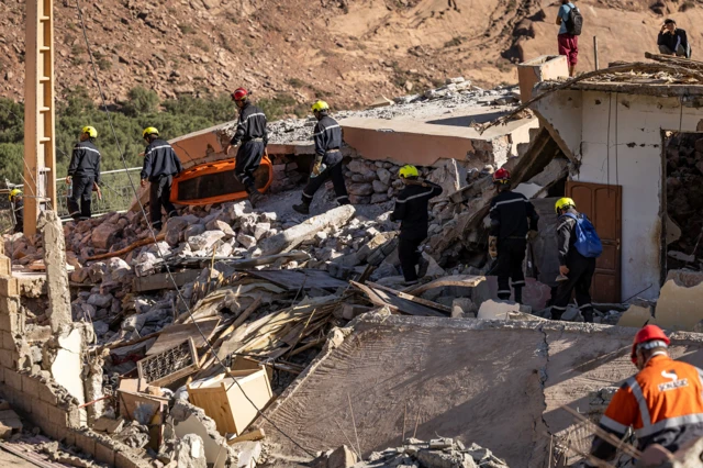 Volunteers search for survivors in the rubble in the village of Talat N'Yacoub, south of Marrakech on 11 September