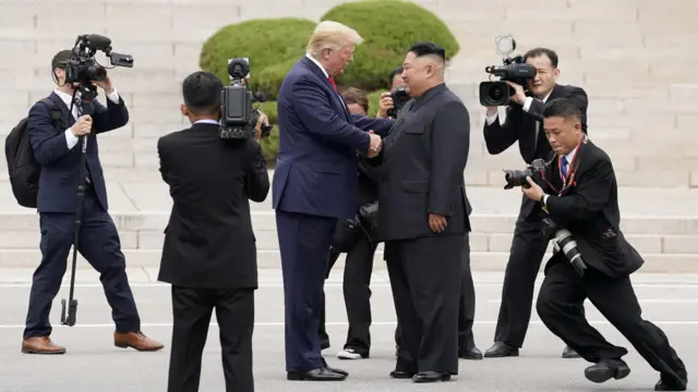 Donald Trump shakes hands with Kim Jong Un in the demilitarized zone