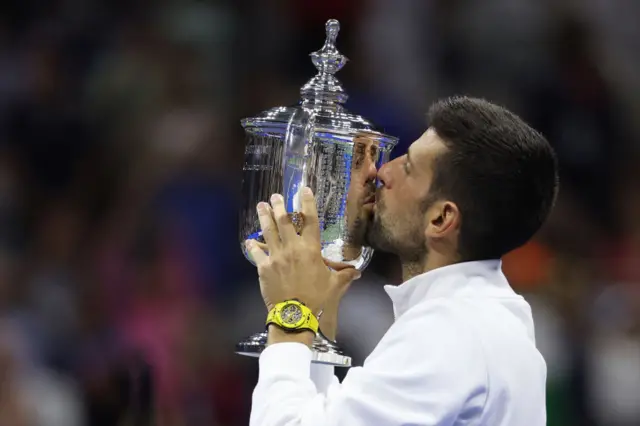 Novak Djokovic kisses US Open trophy