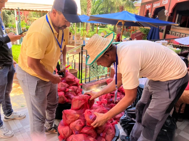 Volunteers hand out bread