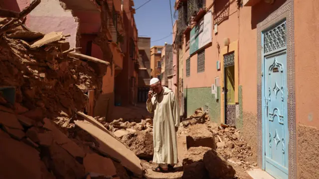 Mohamed Sebbagh, 66, stands in front of his destroyed house, in the aftermath of a deadly earthquake, in Amizmiz, Morocco, September 10