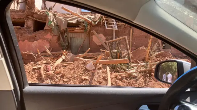 Rubble seen through car window in Ourigane, Morocco