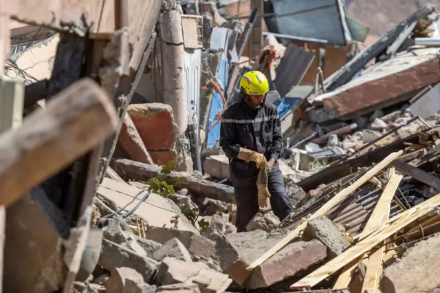 A rescue worker search for suvivors in the rubble of earthquake-damaged houses in Talat-n-Ya'qoub, Al-Haouz province, on September 11, 2023.