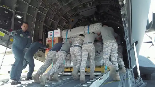 Plane being loaded with aid