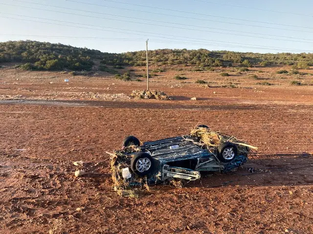 Overturned car on a washed out road