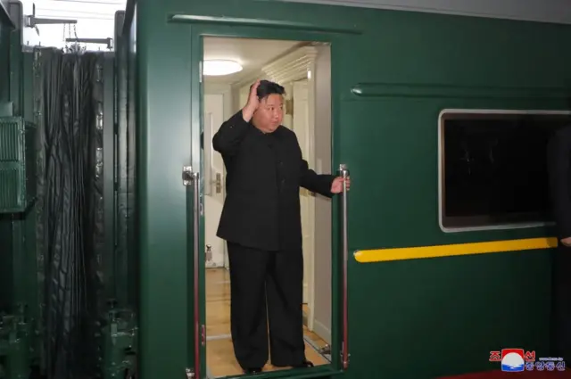 Kim Jong Un waving from his train as he departs Pyongyang for Russia