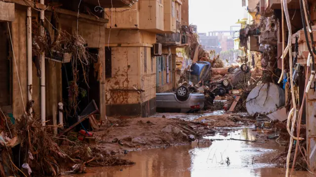 Overturned cars lay among other debris caused by flash floods in Derna, eastern Libya, on September 11, 2023