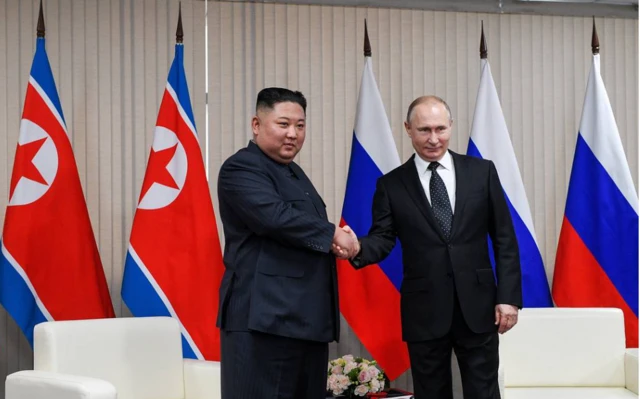 Kim Jong Un shaking hands with Vladimir Putin at a meeting in Vladivostok in 2019