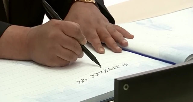 Kim Jong Un writes in the Vostochny Cosmodrome visitor book