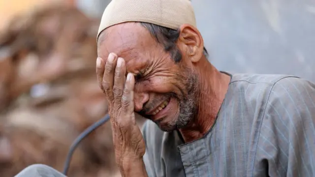 Egyptian Hassan El Salheen weeps after burying the repatriated body of his son, Aly, who died along with his three cousins in Libya - Al Sharief village in Bani Swief province, Egypt, 13 September 2023