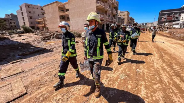 Members of the rescue team from the Egyptian army walk on the street in Derna