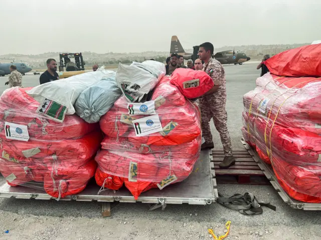 Jordanian military personnel arranges relief items from the Jordan Hashemite Charity Organization to be delivered to Libya