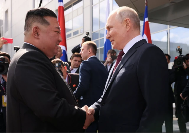 Putin and Kim shake hands at Vostochny Cosmodrome