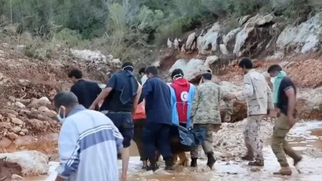 Libyan Red Crescent volunteers take part in a rescue operation in an unidentified location in Libya